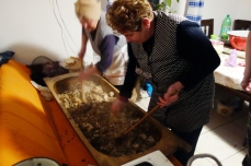 The ladies toil for close to 20 minutes over the trough, mixing the herbs, rice and innards into a homogenous filling.
