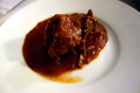 Beef wrapped around ham with tomato sauce